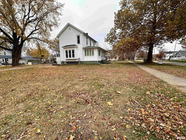 view of property exterior featuring a lawn