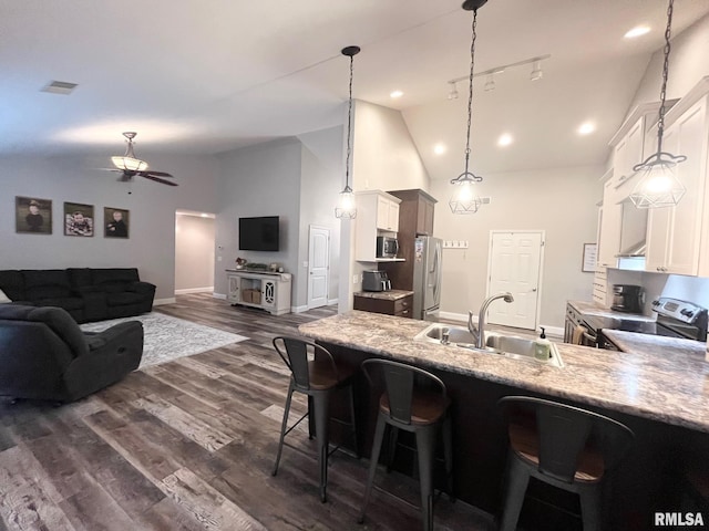 kitchen with white cabinetry, sink, dark wood-type flooring, stainless steel appliances, and pendant lighting