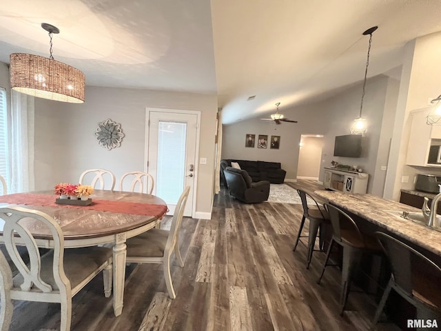 dining room featuring ceiling fan, dark hardwood / wood-style floors, and vaulted ceiling