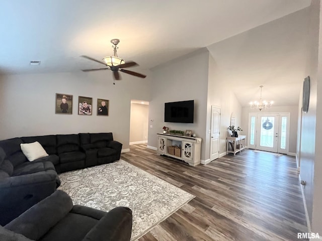 living room with ceiling fan with notable chandelier, dark wood-type flooring, and lofted ceiling