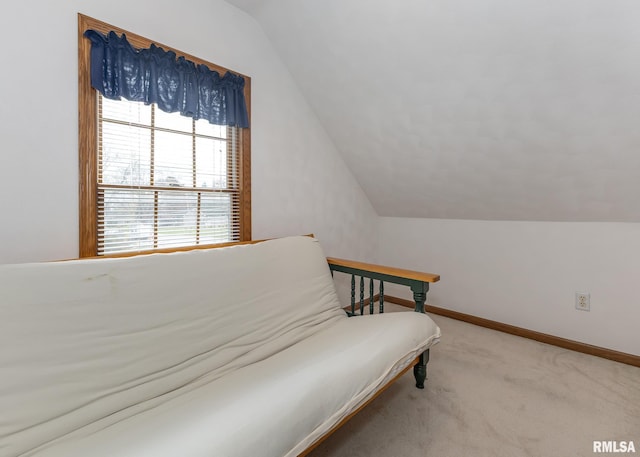 sitting room featuring carpet and vaulted ceiling