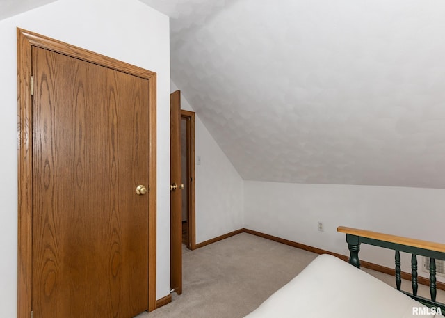 carpeted bedroom featuring vaulted ceiling