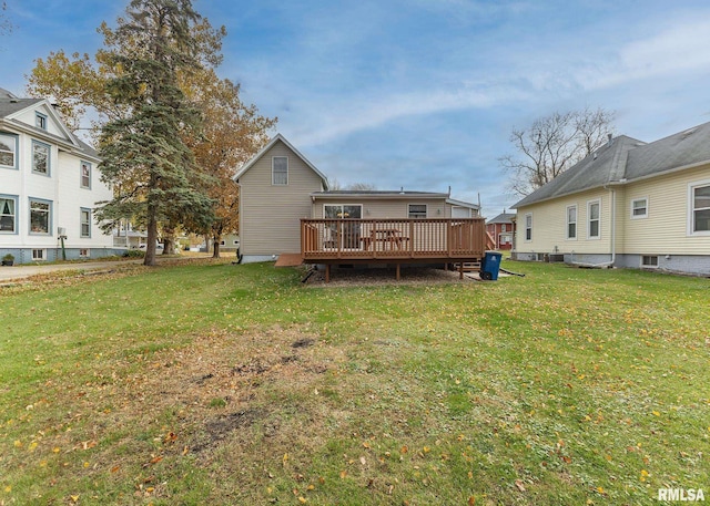 back of property featuring a yard and a deck