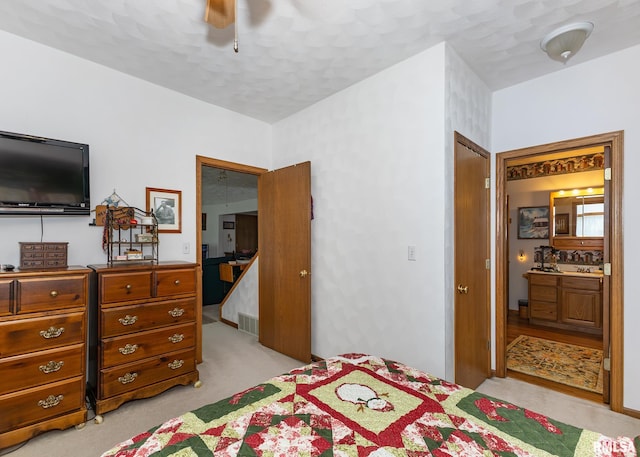 carpeted bedroom with connected bathroom