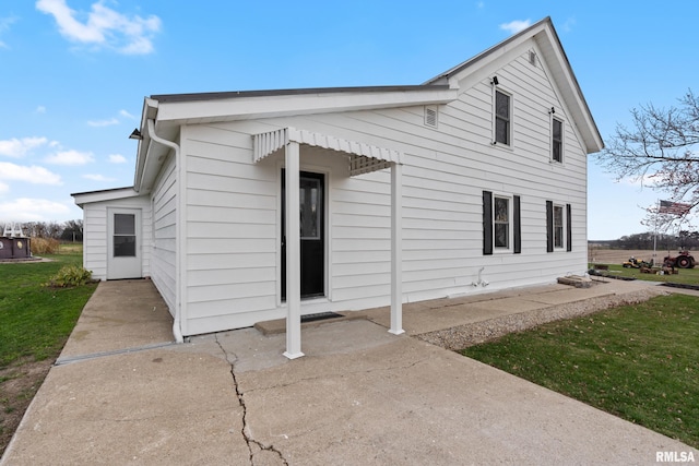 view of property exterior featuring a patio area and a yard