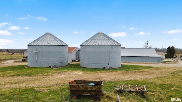 view of outdoor structure with a lawn and a rural view