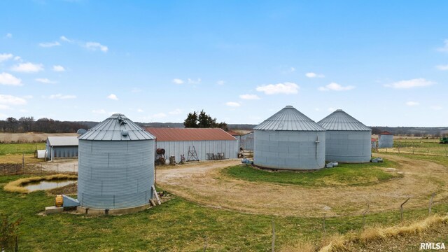 view of outdoor structure with a rural view and a yard