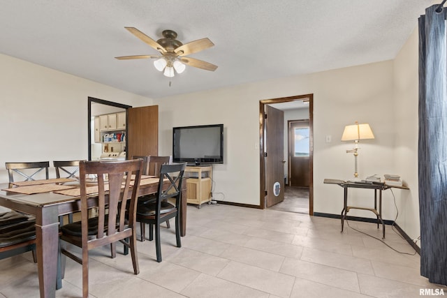 tiled dining room featuring a textured ceiling and ceiling fan