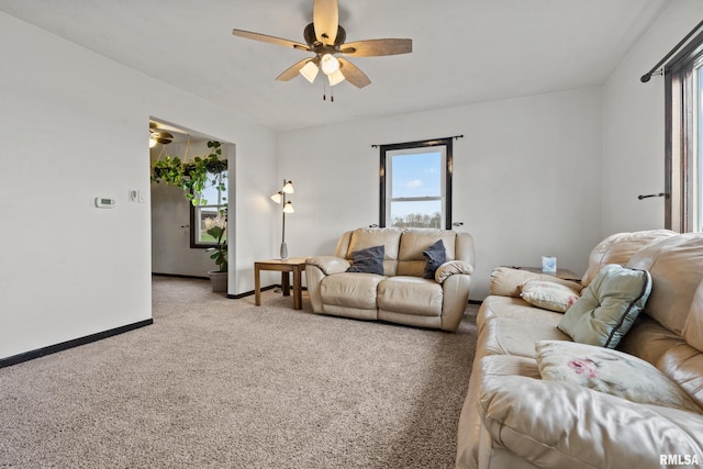 living room featuring carpet flooring and ceiling fan