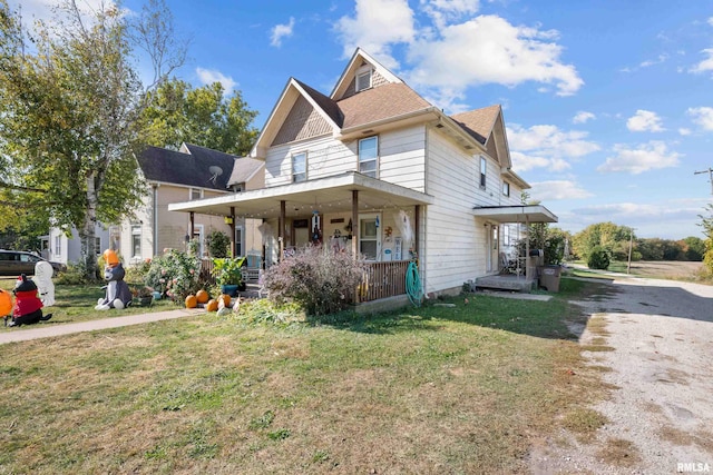 view of front of house with covered porch and a front yard