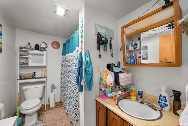 bathroom featuring vanity, toilet, and walk in shower