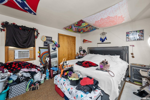 carpeted bedroom with a closet and cooling unit