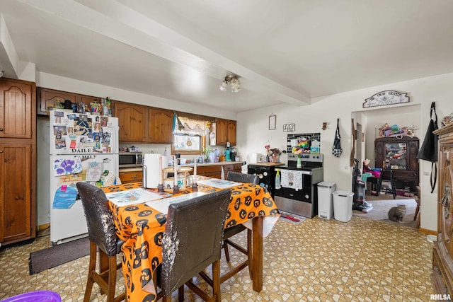 dining area with beam ceiling