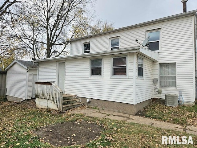 rear view of house with central AC