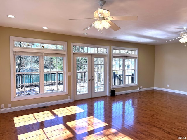 doorway with french doors, ceiling fan, and dark wood-type flooring