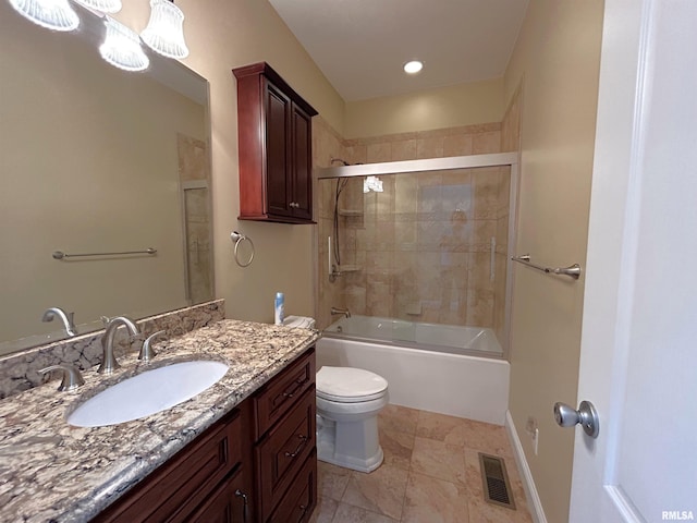 full bathroom with vanity, bath / shower combo with glass door, and toilet