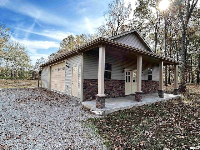 view of home's exterior featuring a porch and a garage