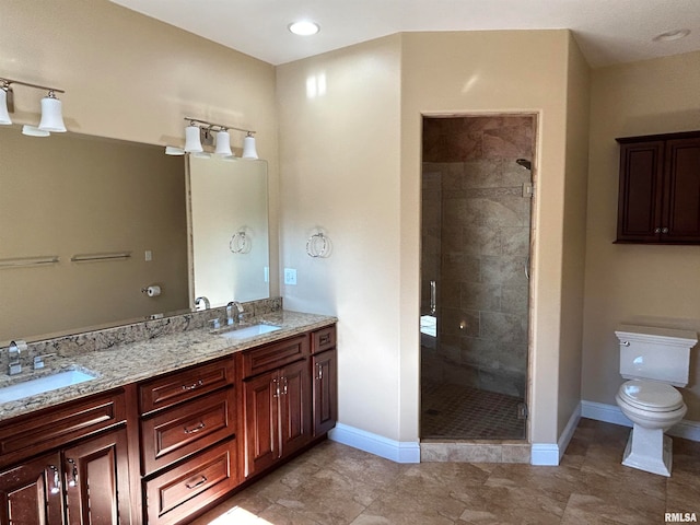 bathroom featuring toilet, vanity, and tiled shower