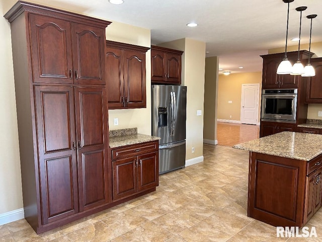 kitchen with decorative light fixtures, a center island, light stone counters, and stainless steel appliances