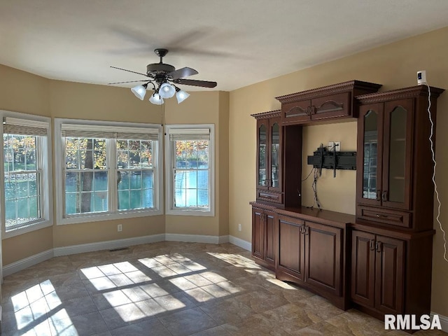 unfurnished dining area with ceiling fan