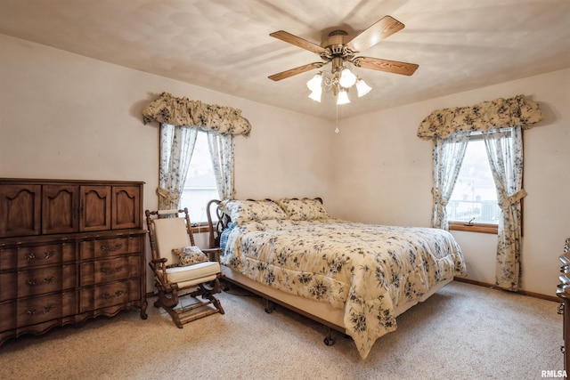 bedroom with ceiling fan and light colored carpet