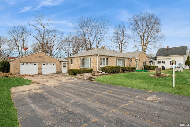 single story home with a front yard and a garage