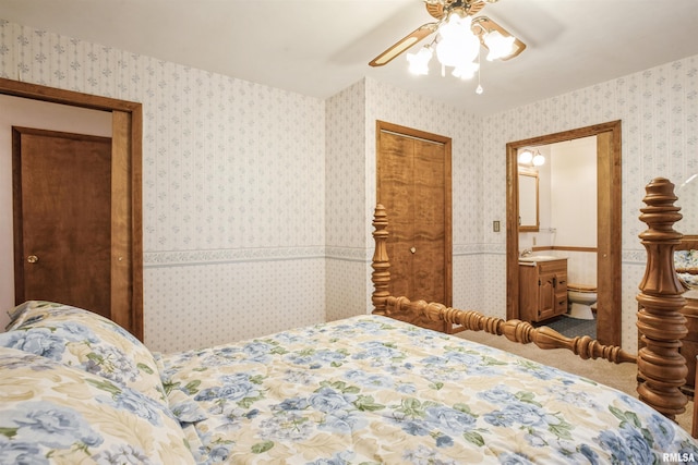 carpeted bedroom featuring ceiling fan and sink