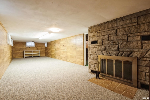 basement featuring a fireplace and carpet floors