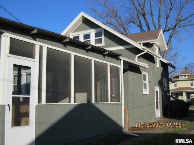 view of side of home featuring a sunroom