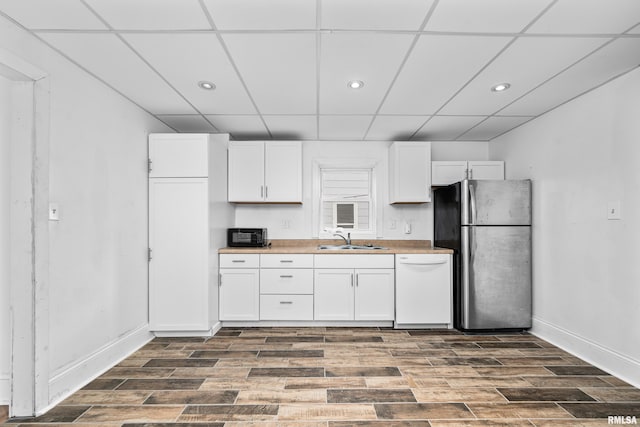 kitchen featuring white dishwasher, dark hardwood / wood-style floors, white cabinets, and stainless steel refrigerator