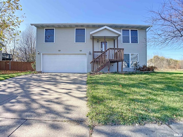 raised ranch with a garage and a front lawn