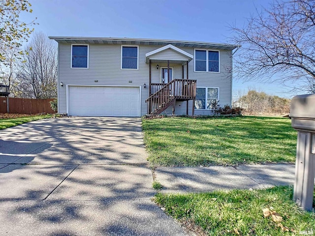 raised ranch featuring a front yard and a garage