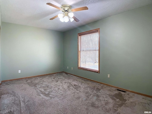 unfurnished room featuring carpet, a textured ceiling, and ceiling fan