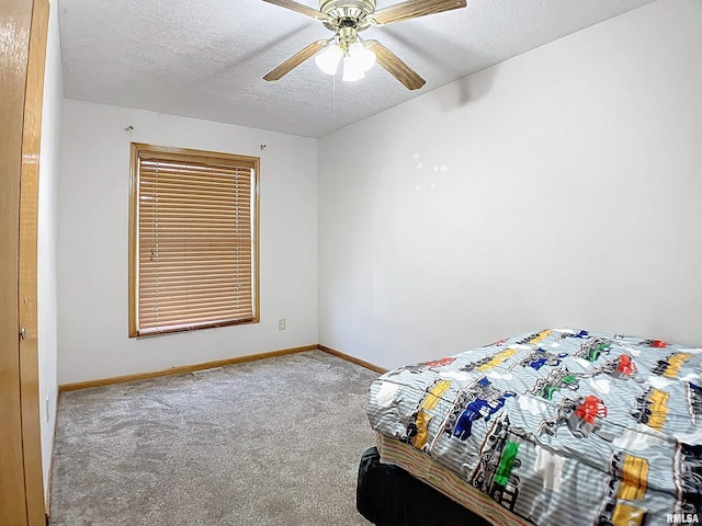 carpeted bedroom with a textured ceiling and ceiling fan