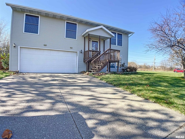 split foyer home with a garage and a front lawn