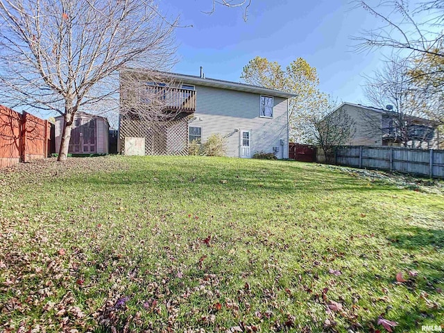 rear view of house with a yard and a storage unit