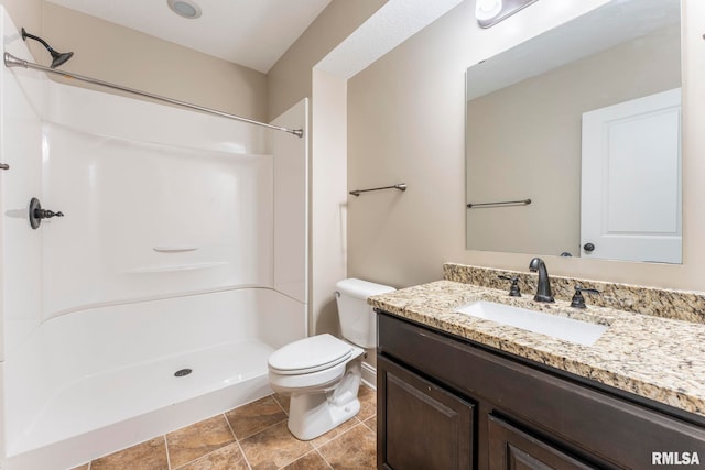 bathroom with walk in shower, vanity, and toilet