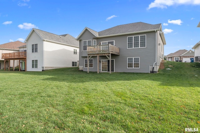 rear view of house with a wooden deck, cooling unit, and a lawn