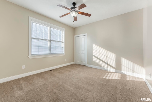 empty room featuring carpet and ceiling fan