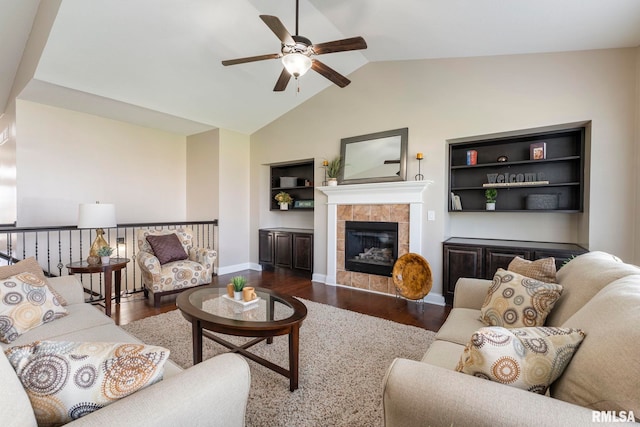 living room with a fireplace, ceiling fan, lofted ceiling, and dark wood-type flooring