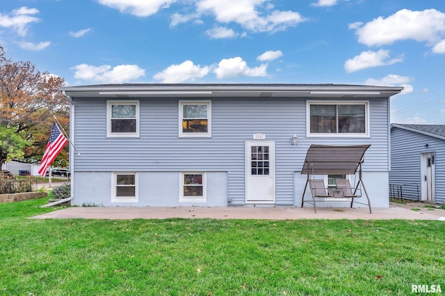 rear view of property featuring a yard and a patio