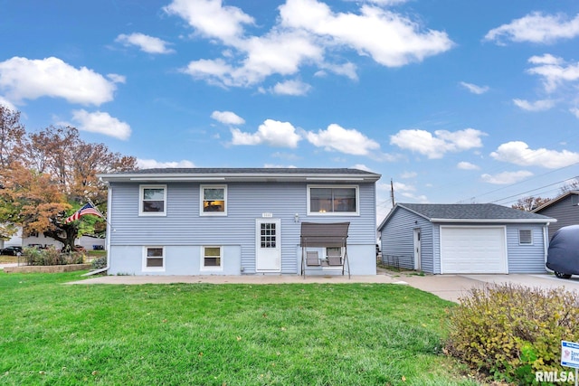 view of front facade with a front lawn, an outdoor structure, and a garage