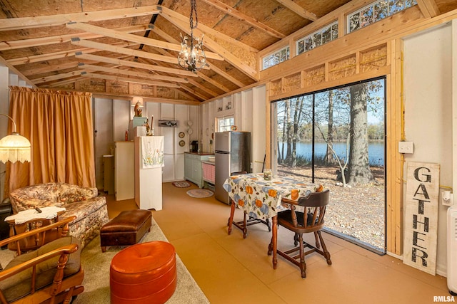 dining space featuring a water view and vaulted ceiling