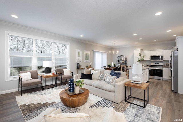 living room featuring light hardwood / wood-style floors, ornamental molding, and a chandelier