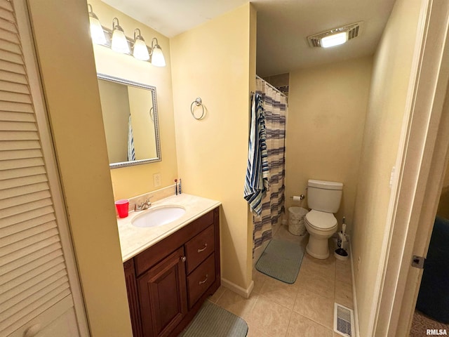 bathroom with tile patterned floors, vanity, and toilet