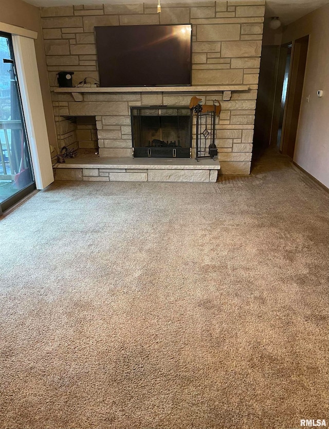 unfurnished living room with carpet and a stone fireplace