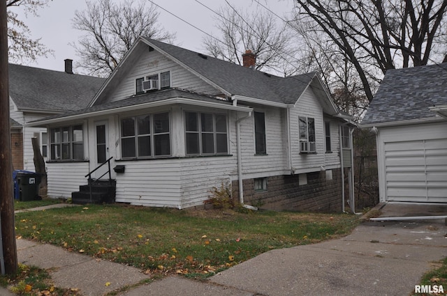 view of front of home with a front yard and a garage