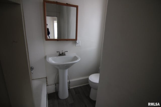 bathroom with sink, wood-type flooring, and toilet