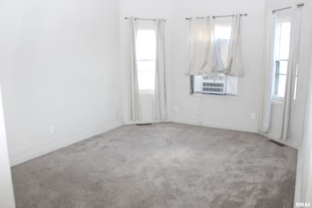 unfurnished room with carpet flooring and cooling unit