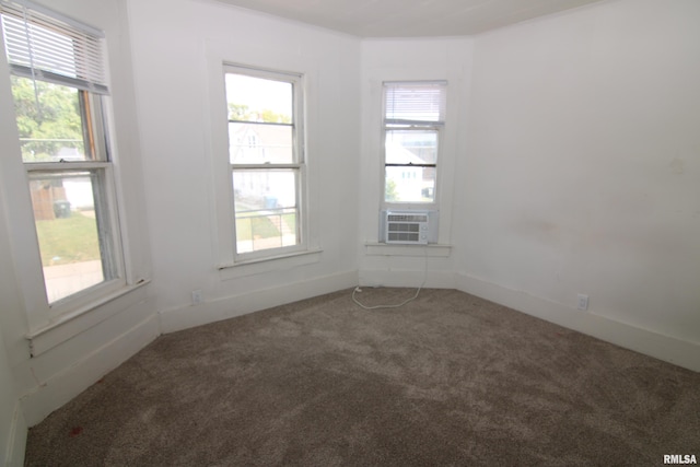 carpeted spare room featuring cooling unit